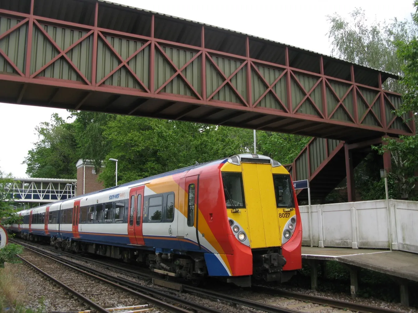 Train and footbridge at Bracknell station in May 2014