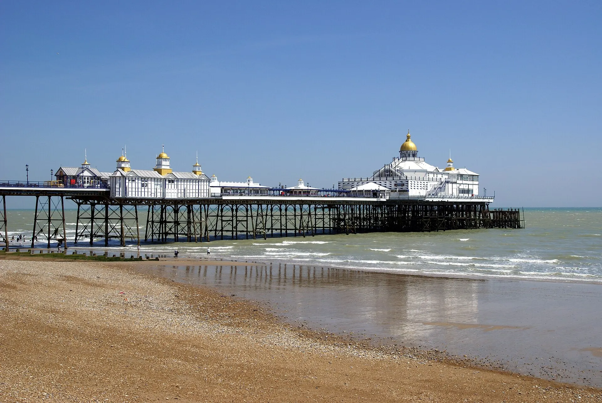 Eastbourne Pier and beach under a blue summer sky in August 2017