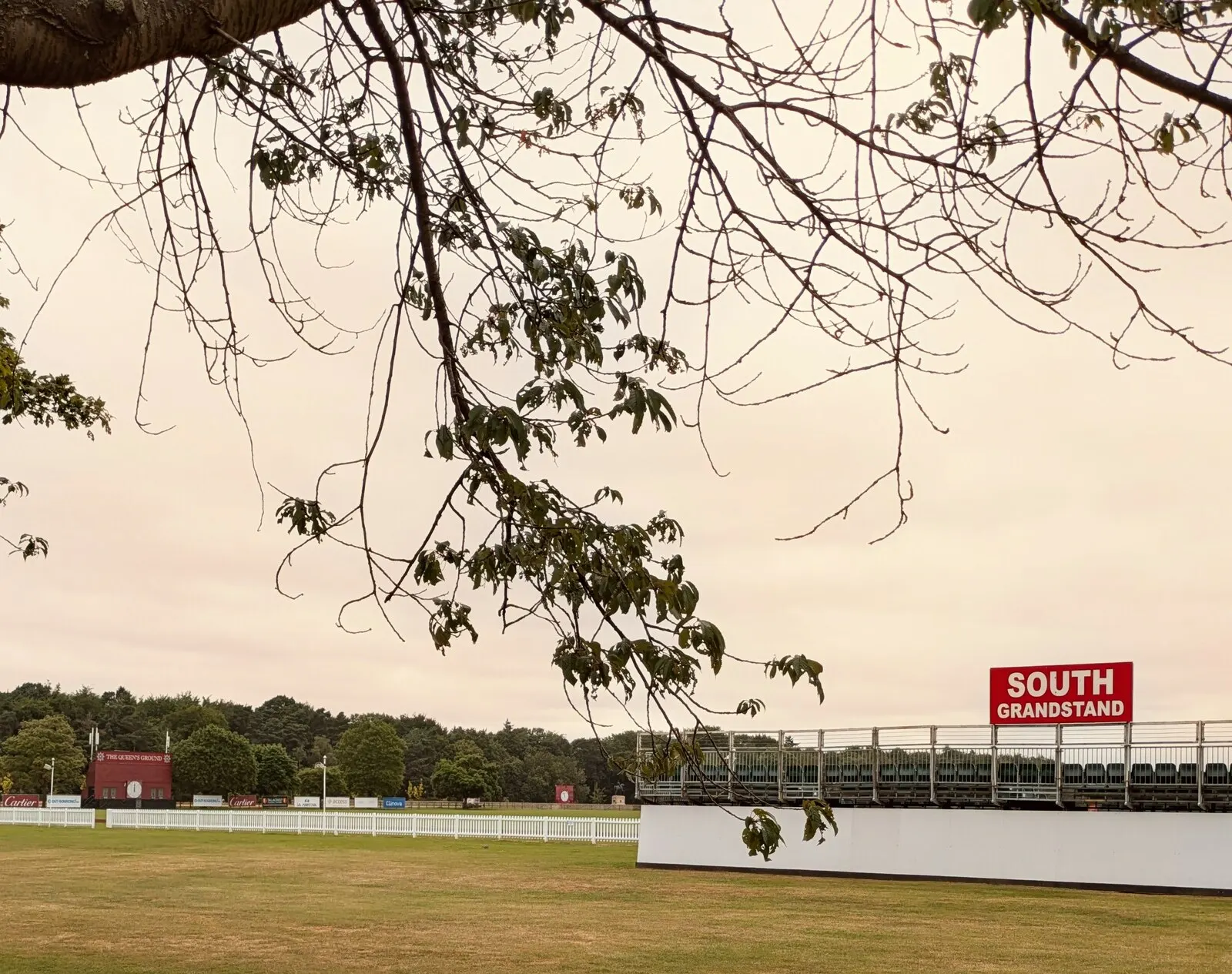 The Queen’s Ground scoreboard and grandstand at Guards Polo Club in 2024