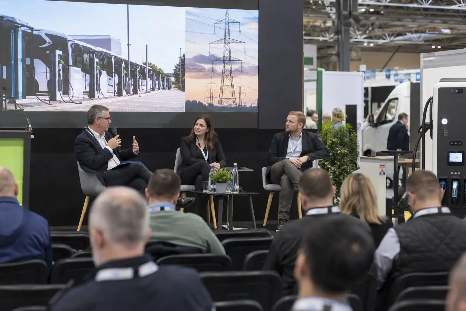 Illustrative EV-infrastructure panel discussion in a trade-show theatre