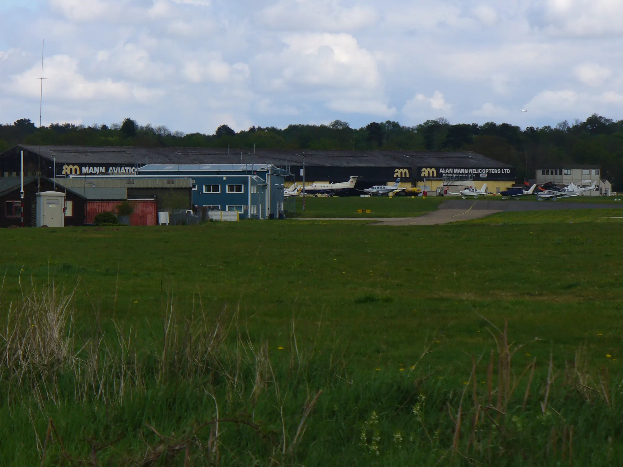 Fairoaks Airport hangars and light aircraft photographed from across the airfield in 2010