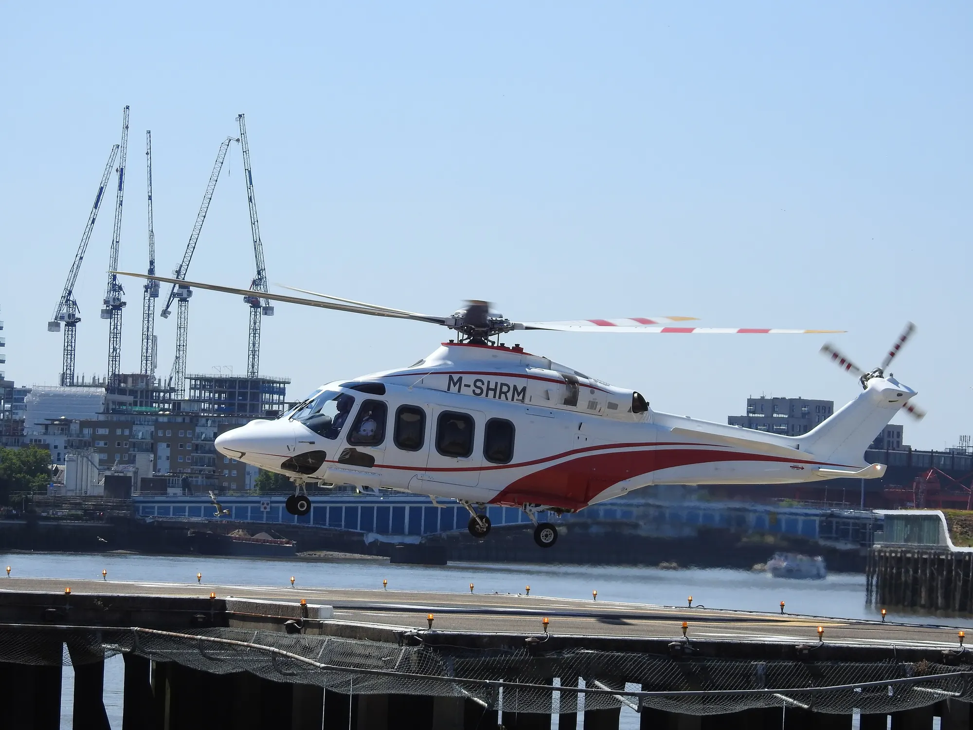Helicopter approaching the London Heliport riverside landing pad in August 2022