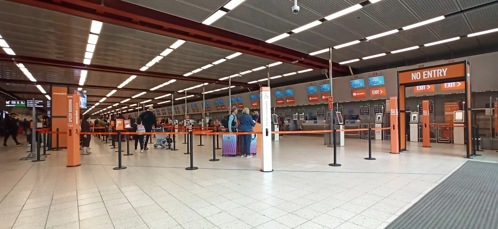 London Luton Airport public check-in desks photographed in April 2024; use current airline and zone signs