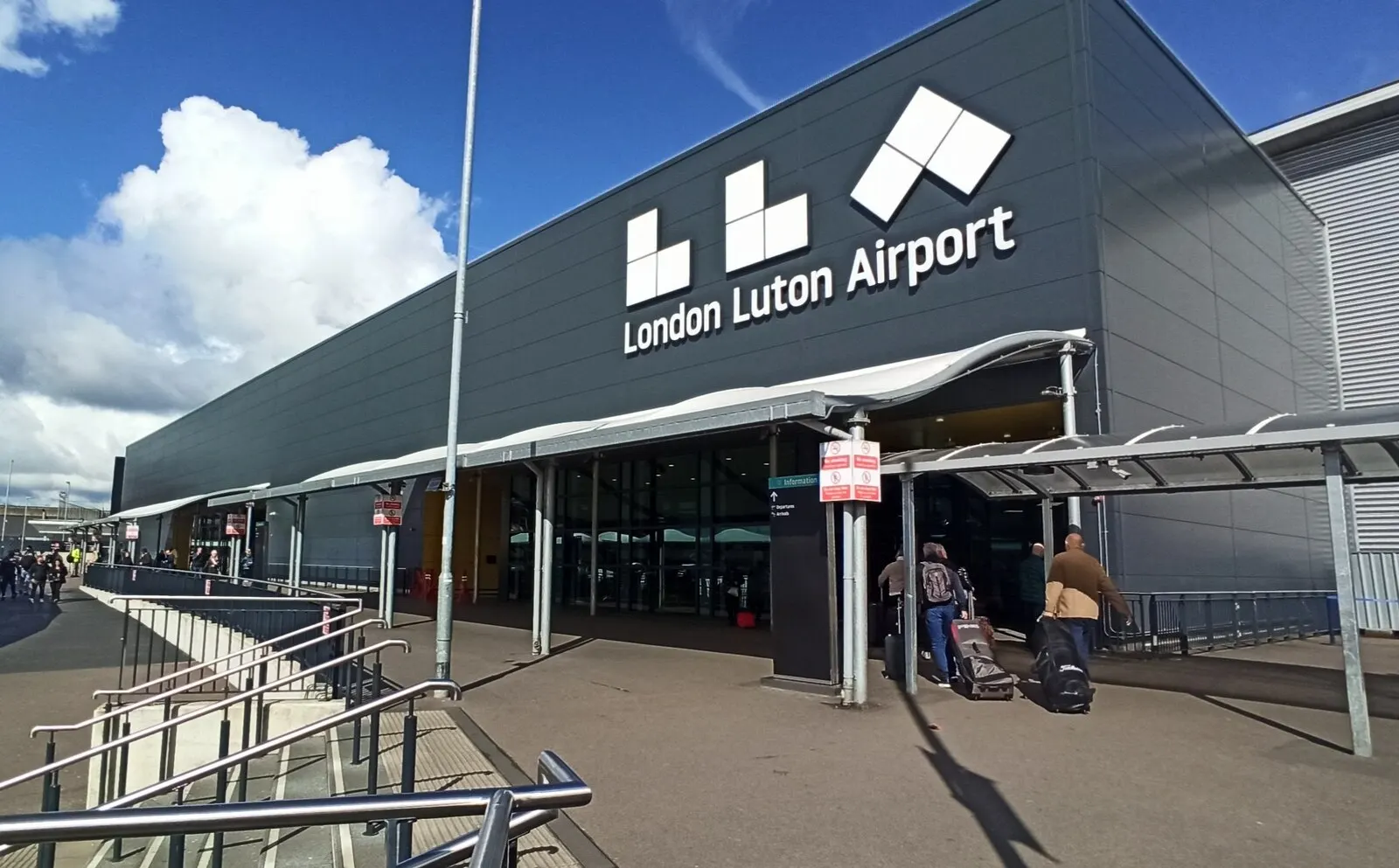 London Luton Airport public terminal entrance photographed in April 2024; follow current parking and pedestrian signs
