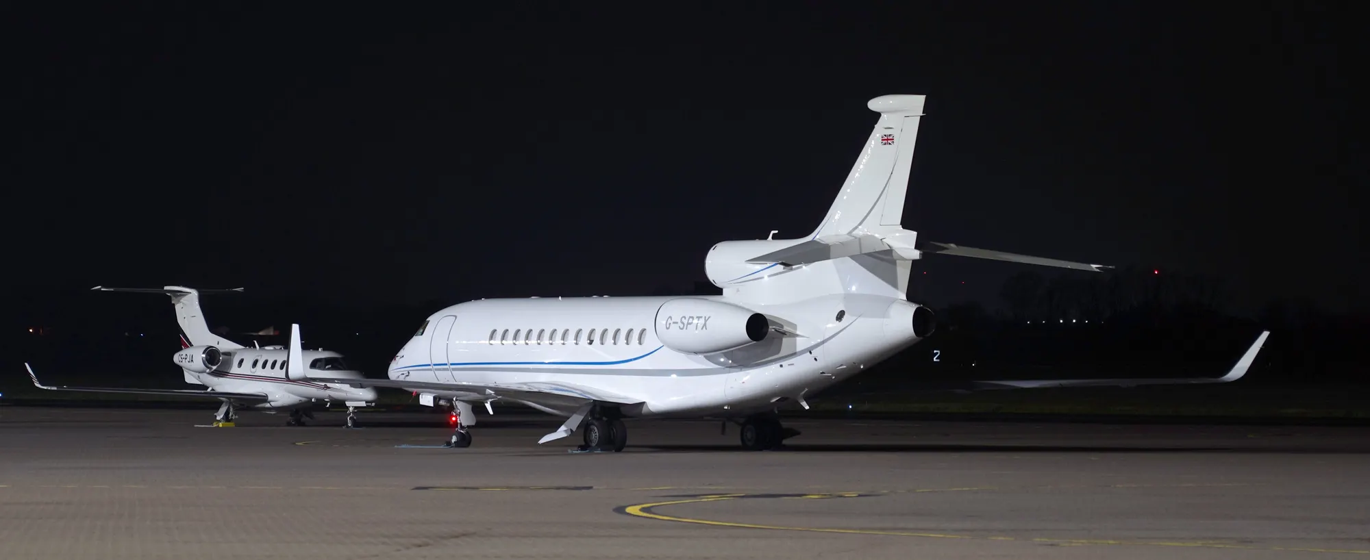 Two business jets on the RAF Northolt apron during a March 2024 night photography session