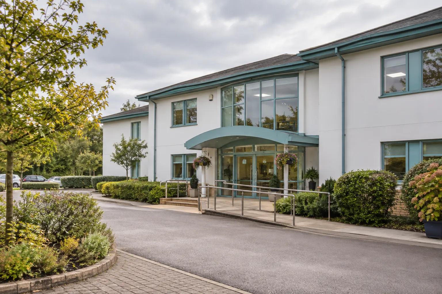 Illustrative white and teal entrance at Spire Thames Valley Hospital
