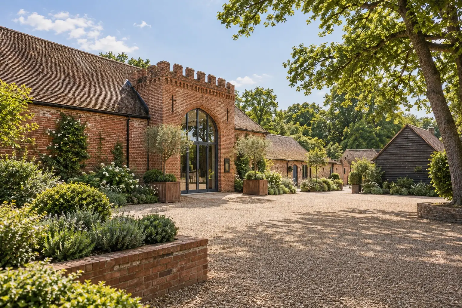 Illustrative spring view of Wasing Park's red-brick Castle Barn and courtyard