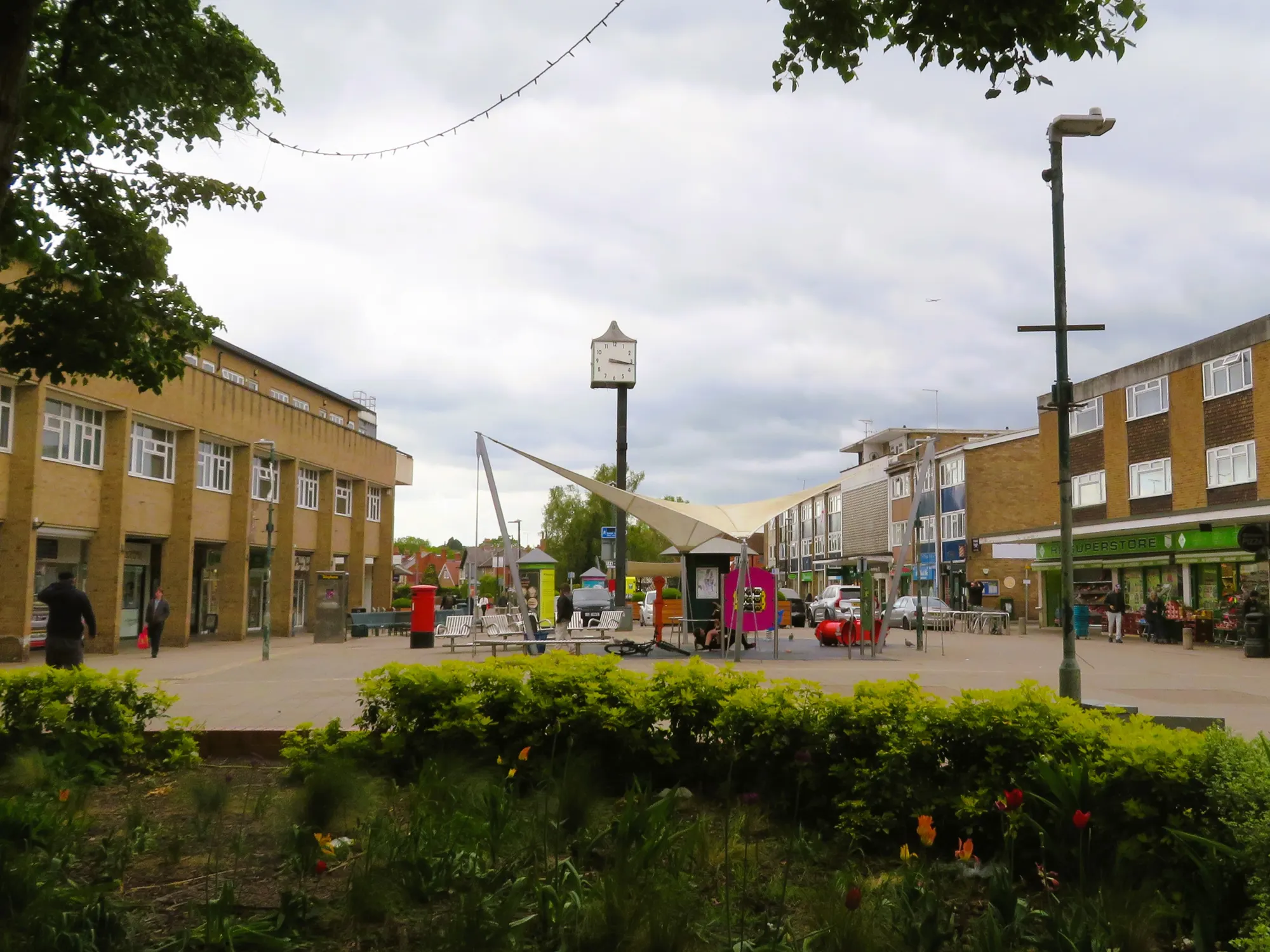Woodley town-centre shops and clock on Crockhamwell Road, photographed in 2025
